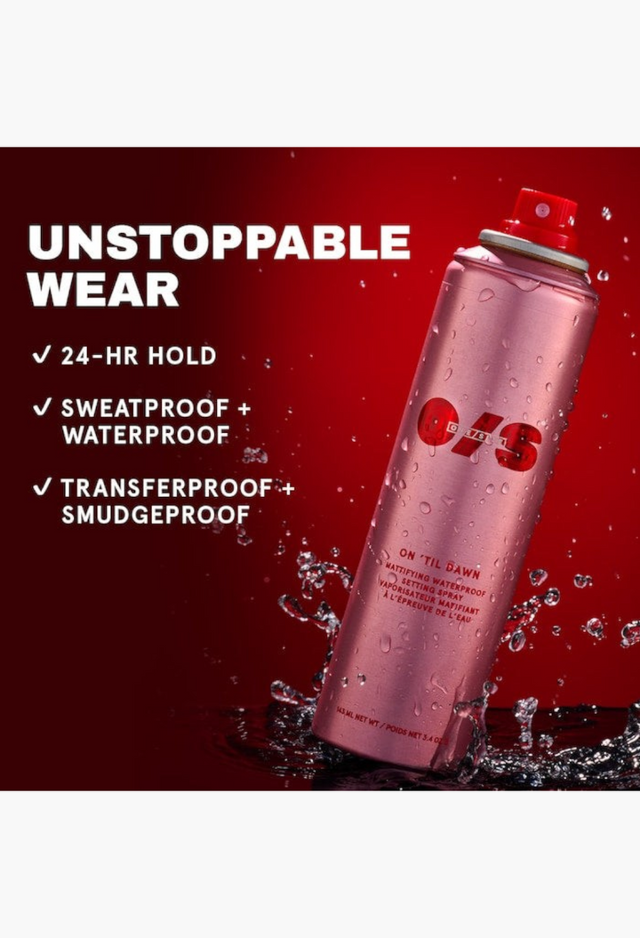 GLAM MODA On 'Til Dawn mattifying waterproof setting spray in a metallic pink aerosol bottle with water droplets.