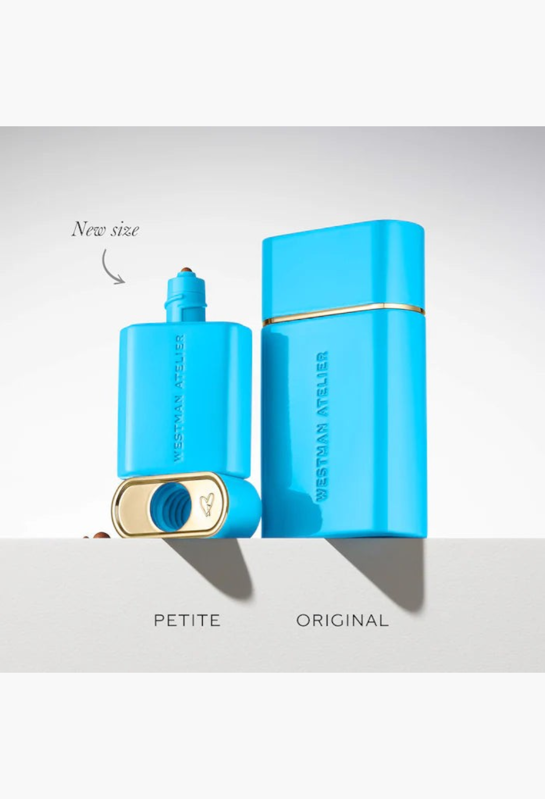 GLAM MODA Westman Atelier petite and original size bronzing drop bottles in bright blue packaging on a white surface