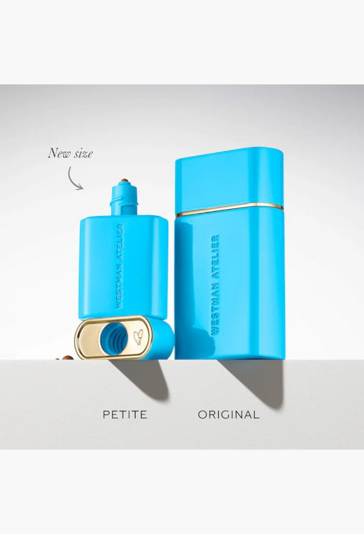 GLAM MODA Westman Atelier petite and original size bronzing drop bottles in bright blue packaging on a white surface