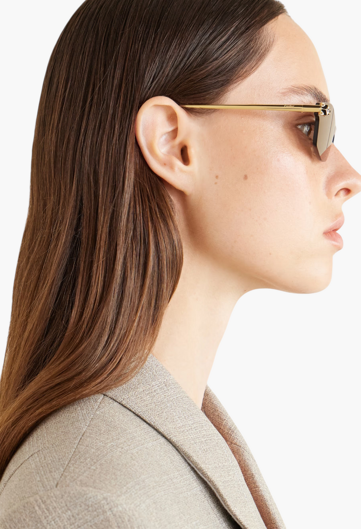 GLAM MODA Cartier Panthère D-frame sunglasses with gold-tone metal frames and purple lenses on a model profile view